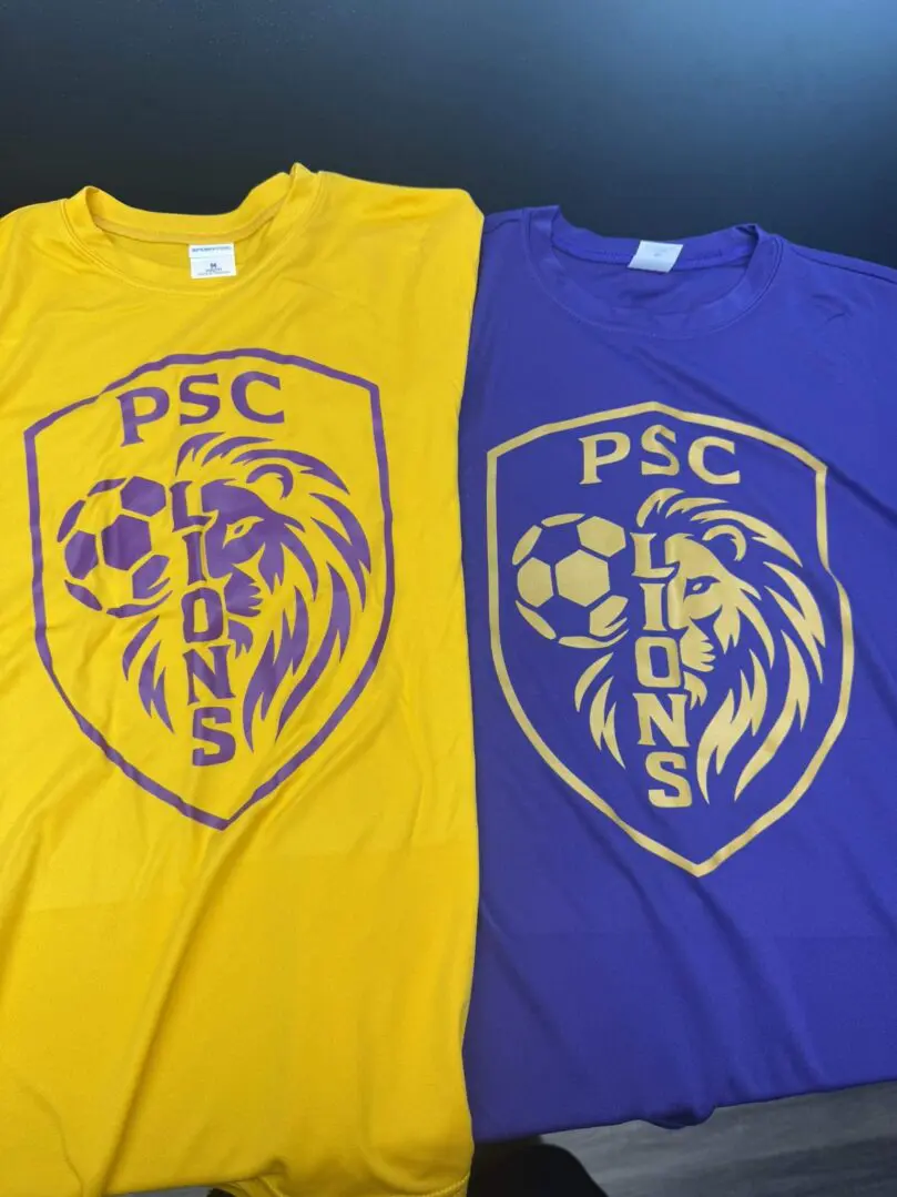 Two PSC Lions sports jerseys, one in yellow and one in purple.