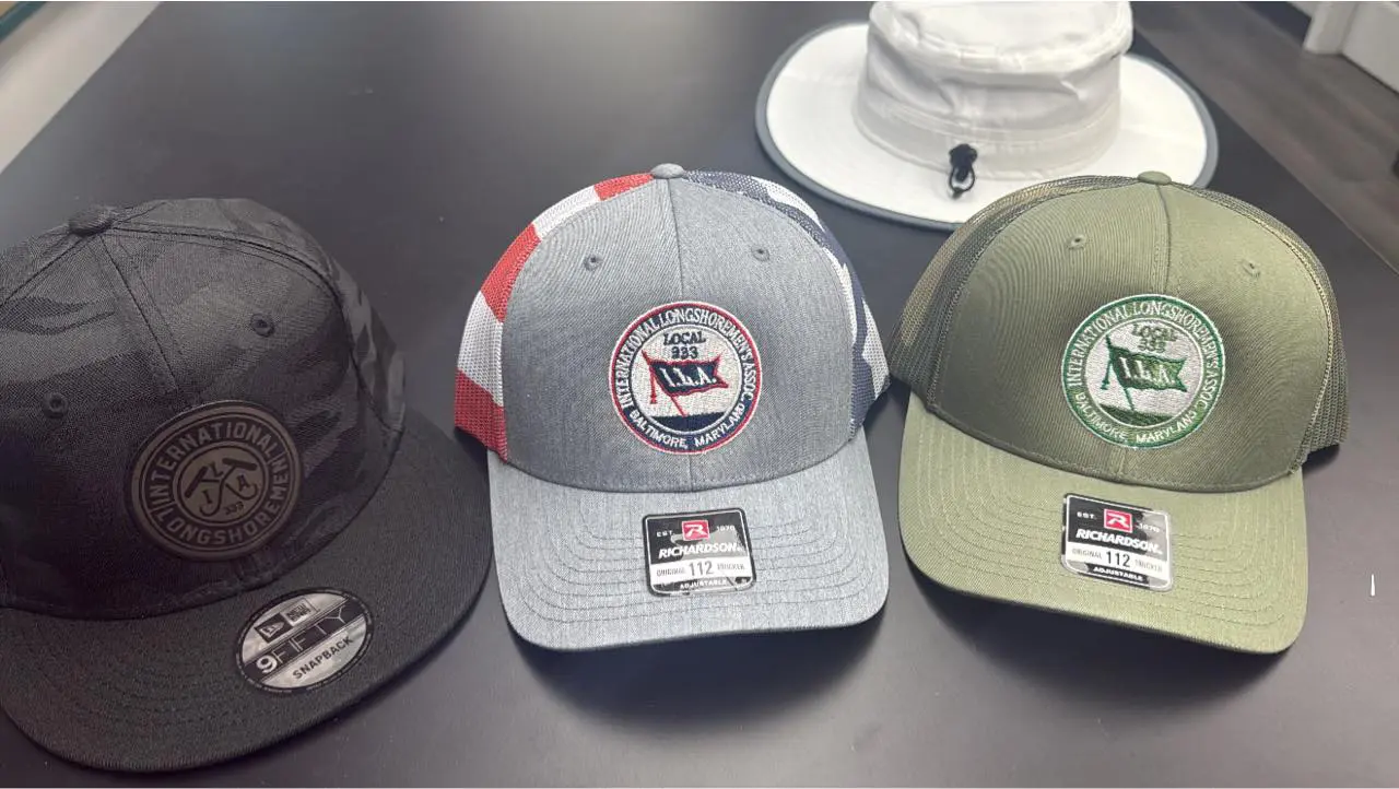 Three baseball caps in different colors displayed on a surface.