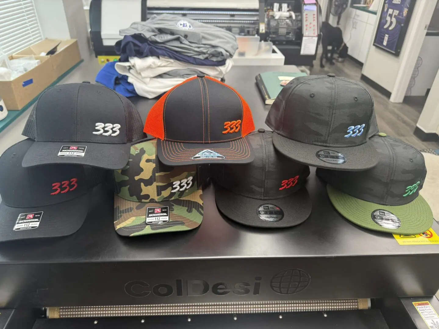 A collection of various baseball caps arranged on a table.