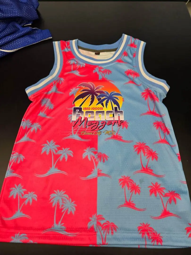 Colorful sleeveless shirt with a tropical sunset and palm tree design.